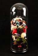 An antique floral wool work display, housed under glass dome, 19th century, the display 33cm high, the dome 49cm high overall