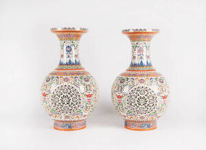A large pair of pierced and articulated Chinese polychrome enamel ovoid vases with removable inserts, 53cm high