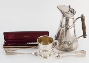 A silver plated Arts & Crafts water jug, Whitehill cheese knife with sterling silver handle (boxed), a sterling silver christening mug (107 grams), and two sugar tongs, 19th and 20th century, (5 items), the largest 21cm high