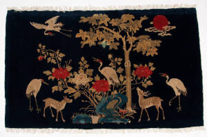 Two Chinese deep blue ground baotou rugs, decorated with crane and deer, 93 x 166 and 130 x 68