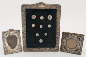 Three antique sterling silver picture frames, the largest housing an array of Chinese porcelain buttons, 19/20th century, the largest 25cm high