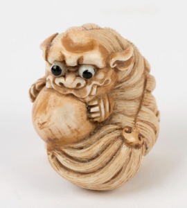 An antique Chinese carved marine ivory Foo dog ornament, 19th/20th century, 3cm high, 4.5cm long