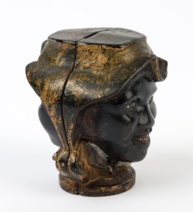 An antique American double-sided cast metal moneybox with African-American faces, 19th/20th century, ​​​​​​​8cm high