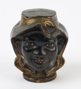 An antique American double-sided cast metal moneybox with African-American faces, 19th/20th century, ​​​​​​​8cm high - 2