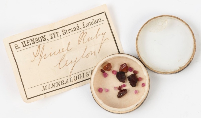 NATURAL RUBIES, group of 16 specimens, housed in circular card box with label and note "S. HENSON, 277, STRAND, LONDON, MINERALOGIST, Spinel Ruby, Ceylon", 19th century