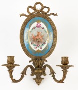 An antique French porcelain two branch wall sconce with gilt metal surround, 19th century, 36cm high