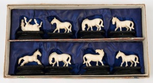 A set of eight Chinese carved ivory horse statues on carved wooden stands, housed in original fitted box, the largest 5cm high overall