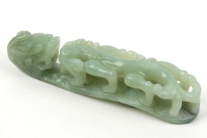 A Chinese carved jade toggle amulet with dragon decoration, 19th/20th century, 12cm long