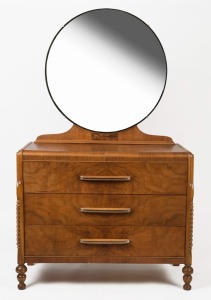 An Art Deco style walnut veneered dressing chest of three drawers with split barley twist column decoration, turned feet and circular mirror plate to the back, circa 1950, 176cm high, 107cm wide, 49cm deep