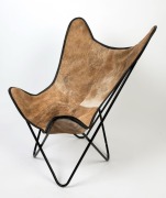 A reproduction&nbsp;sling chair, black metal with cow hide covering, 100cm high, 83cm wide, 71cm deep. - 2