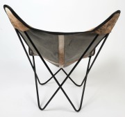 A reproduction&nbsp;sling chair, black metal with cow hide covering, 100cm high, 83cm wide, 71cm deep. - 3