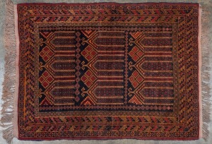 A hand-knotted black and red tribal rug, 145 x 100cm.