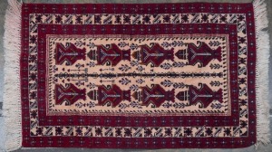 A red and cream hand-knotted rug, together with a brown, blue and cream tribal rug, (2 items), The larger 165 x 93cm.