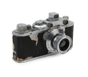 CANON: NS rangefinder camera [#10880], c. 1941, with Nikkor 50mm f3.5 lens [#501380] in shutter #1917. Featuring pop-up rangefinder and 'Canon Seiki-Kogaku' engraving on top plate. With Canon ERC with straps. [NB: While the vulcanite body covering has det