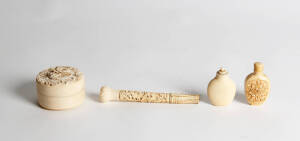A collection of four Chinese ivory pieces, mostly Qing Dynasty, comprising a dragon carved parasol handle 14cm long, a flower carved circular box and cover 6.5cm diameter and two snuff bottles, 6 and 7cm high