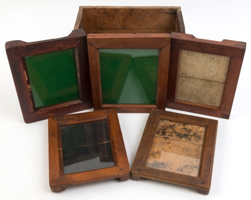 Five assorted wooden camera plates housed in timber box, ​​​​​​​the box 28cm wide