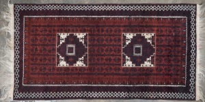 A Turkoman brown and burgundy hand-knotted tribal rug, ​​​​​​​220 x 104cm