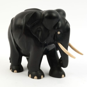 A vintage carved ebony elephant statue with bone tusks and toes, early 20th century, 23cm high