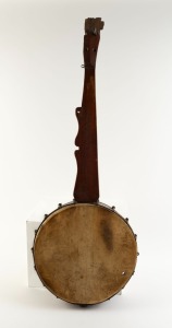 An antique American five string banjo, folk art construction with hide drumhead, mid 19th century, 111cm long, the drum head 39.5cm diameter.