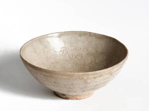 A Chinese stoneware bowl with a moulded floral design in the centre, Song Dynasty 960-1279, 17.9cm diameter