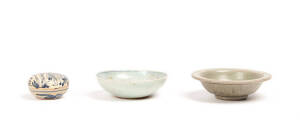 A Chinese Longquan celadon twin fish plate, Yuan Dynasty 1279-1368, a blue and white small box and cover and saucer dish with biscuit fish, Ming Dynasty, 12.5cm, 6.5cm and 12cm diameter