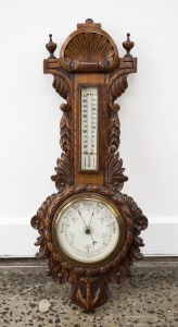 An antique English aneroid wall barometer with mercury thermometer in carved oak case, 19th century, 59cm high