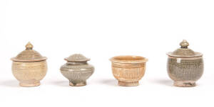 Three celadon glazed pots and covers and one bowl, 10.2, 7.3, 10cm high and 9cm diameter