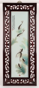 A vintage Chinese porcelain screen, adorned with fish and poem, housed in a carved timber frame, 20th century, 96 x 40cm overall.