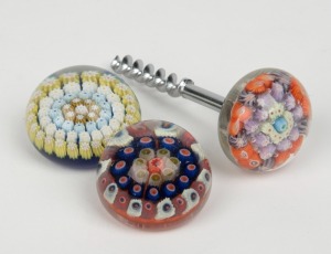 Two millefiori glass paperweights, together with a millefiori corkscrew, (3 items) the corkscrew 10.5cm high