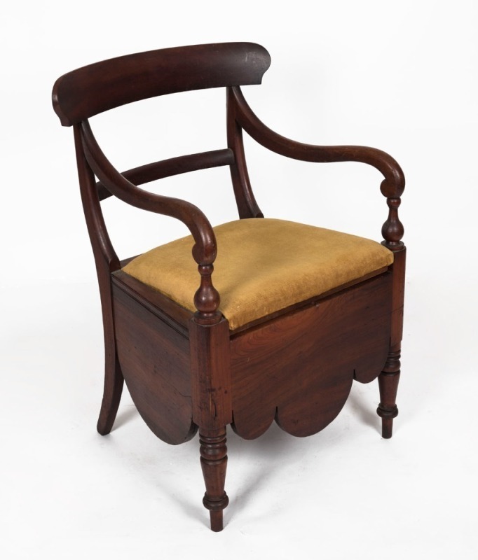 A Colonial Australian cedar spade back commode chair in the manner of Andrew Lenehan, Sydney origin, circa 1850s, 88cm high, 56cm across the arms