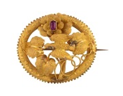 LAMBORN & WAGNER of Melbourne, antique 18ct yellow gold oval brooch adorned with bird and leaves, set with purple stone, 19th century, stamped "L&W" with star marks, 4cm wide, 7.5 grams