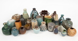 Twenty six assorted small pottery vases, the largest 13cm high