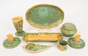 ERIC BRYCE CARTER gum leaf and gumnut green and yellow glazed pottery candle sticks, vase, ginger jar, pen tray, leaf dish, napkin ring and oval bowl, (8 items), all signed "E. Bryce Carter, Sydney, N.S.W.", ​​​​​​​the platter 26cm wide