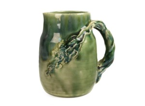 CHARLES DREW green glazed pottery jug with windswept branch handle, incised "Charles Drew", 13.5cm high