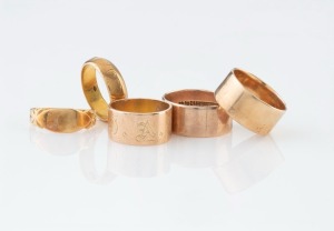 Five antique Australian gold wedding rings, all stamped with maker's marks: I.) FLETT & SONS, PORT PIRIE, 15ct, (5.4 grams), II.) DENIS BR. 18ct, (4.7 grams), III.) WILLIS & SONS, 18ct, (2.7 grams), IV.) T. GAUNT, 9ct (5.3 grams), V.) pictorial fish mark, 15c, (5.2 grams). 23.5 grams total