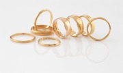 Eight assorted antique and vintage 18ct yellow gold wedding rings, mostly Australian makers, 23.4 grams total