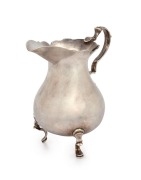 An 18th century CHANNEL ISLANDS silver cream jug by GEORGE HAMON of Jersey, circa 1770, with engraved ownership monograms to base, 10cm high, 116 grams