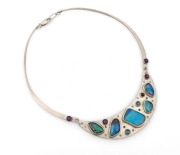 An Australian silver Modernist necklace, set with Queensland boulder opals and amethysts, late 20th century, stamped "P.K. 925", the pendant section 10cm wide