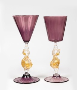 Two Australian art glass goblets executed in the Murano style, with gold foil bird stems and amethyst foot and bowl, circa 2007, engraved signature (illegible), 23.5cm and 24cm high