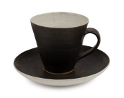 LUCIE RIE wheel-thrown teacup and saucer, stamped "L.R.", the saucer 14cm wide.
