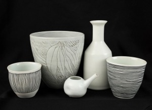 HILLARY JONES cream ceramic bottle vase, a gum leaf vase, two cream beakers with black linear decoration, and a small cream ceramic vessel, (5 items), the largest 18.5cm high