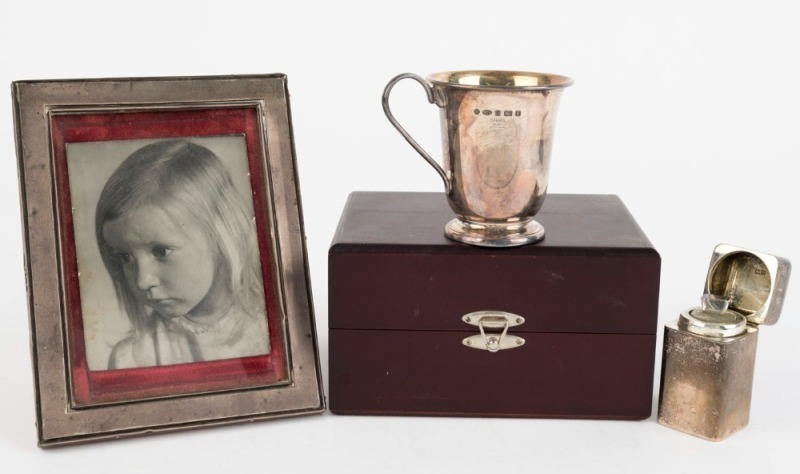 An antique English sterling silver picture frame, sterling silver travelling ink bottle (with glass liner and stopper), and a modern sterling silver christening mug by CARRS of Sheffield, (3 items), ​​​​​​​the frame 16.5 x 13cm overall