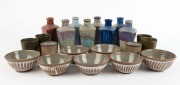 Set of eight Australian pottery bottles, set of four green ceramic beakers, set of seven pottery bowls and a pair of brown glazed beakers, (21 items), ​​​​​​​the largest 19cm high