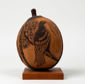 A carved boab nut of impressive proportions, mounted on Queensland silky oak base, 23cm high overall