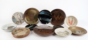 Thirteen assorted pottery plates and dishes, the largest 30cm diameter