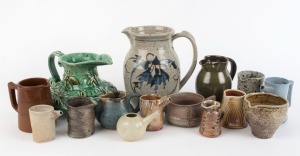 Fifteen assorted pottery jugs including unusual hand-built green example with applied flannel flowers, the largest 22cm high