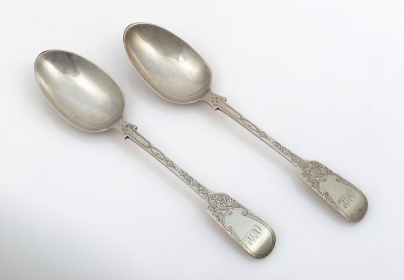 A pair of London made antique CHANNEL ISLANDS bright cut silver serving spoons, retailed by J.P. GENGE of Jersey, circa 1895, the largest 23m long, 162 grams total