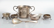 An antique sterling silver Channel Islands style cup by Francis Higgins of London, circa 1886; three antique sterling silver salt cellars, a Channel Islands silver spoon and pap boat, 19th and 20th century, (6 items), the cup 7.5cm high, 318 grams total