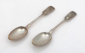 ROYAL JERSEY MILITIA pair of antique English made sterling silver serving spoons with CHANNEL ISLANDS overstruck mark for CHARLES THOMAS MAINE" of Jersey, circa 1913 and 1938, 22.5cm long, 176 grams total