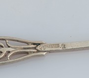 LINTON of Perth set of six Australian silver coffee spoons, two teaspoons, and a pâté knife, all decorated with Western Australian wildflowers, (9 items), stamped "JAL SILVER", the knife 12.5cm long, 100 grams total - 2